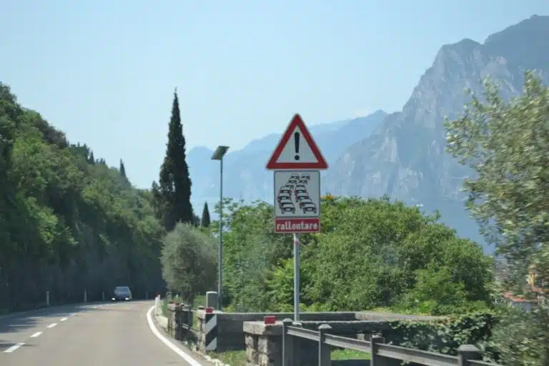 Road sign warns drivers to slow down on mountain road
