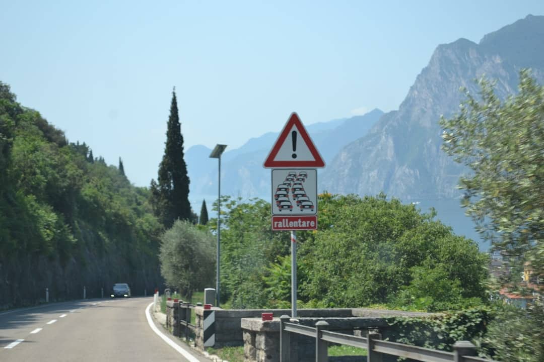 Road sign warns drivers to slow down on mountain road
